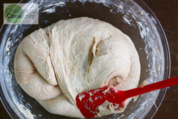 stirring sourdough bread dough