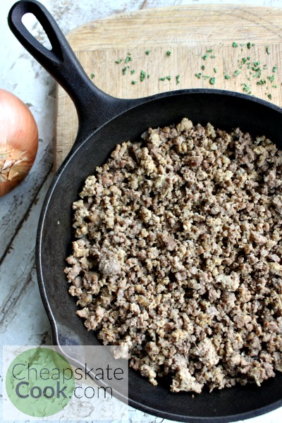 browned ground beef in a cast iron skillet