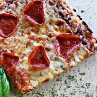Easy, delicious, garlicky pizza crust that you can make with white flour or whole grain. Costs about 70 cents per pizza. So now we can eat more pizza!
