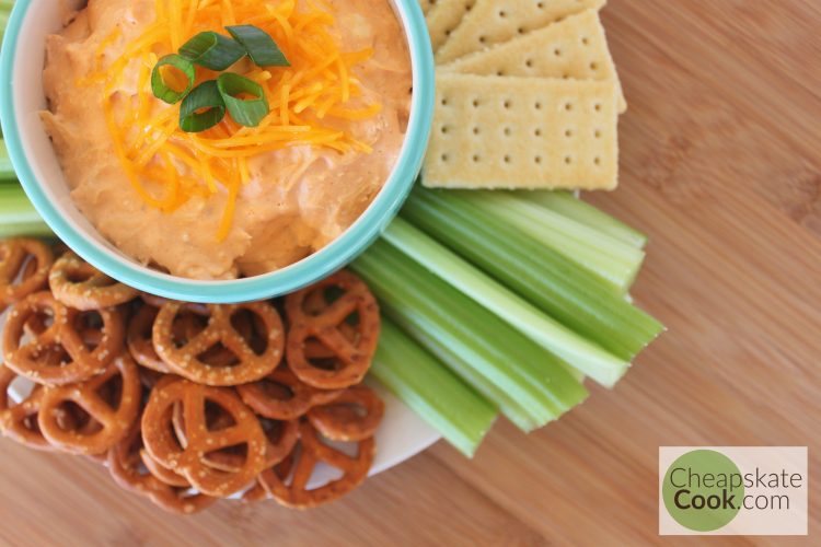 Buffalo Chicken Dip with celery, crackers, and pretzels