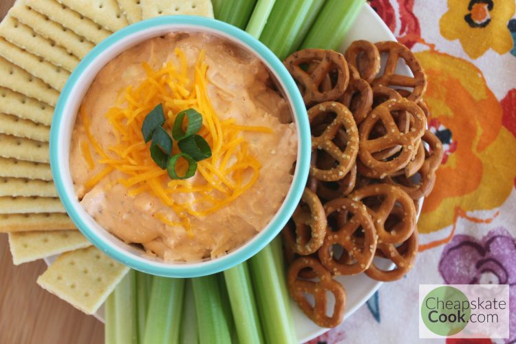 Buffalo Chicken Dip with celery, crackers, and pretzels