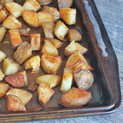 If you're looking for a cheap real food, that keeps stomachs full without a lot of fuss, potatoes are it. These healthier home fries are baked, not fried. They're drizzled with healthy fats, tossed with garlic and paprika, and work perfectly for breakfast as well as dinner. Leftovers crisp up easily in the oven. Gluten-free, dairy-free, egg-free, paleo, and frugal. From CheapskateCook.com
