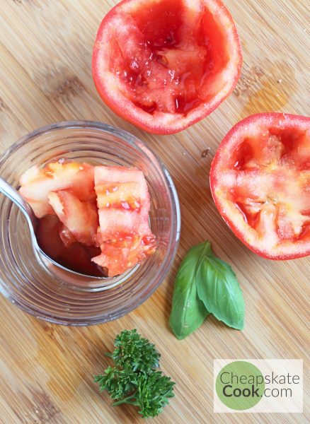 scooping guts out of the tomatoes