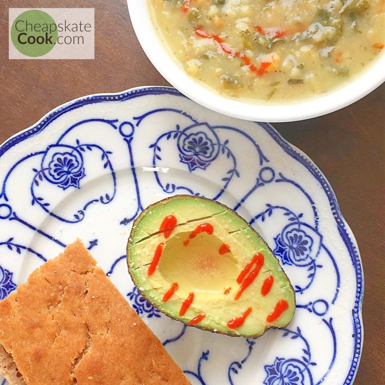 breakfast soup with sourdough bread and an avocado