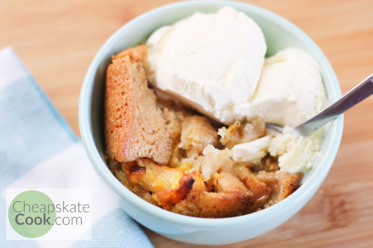 peach cobbler in a bowl with ice cream