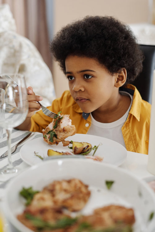 kid eating chicken