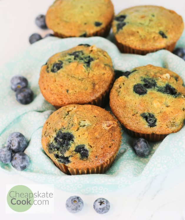 blueberry muffins on a napkin with blueberries
