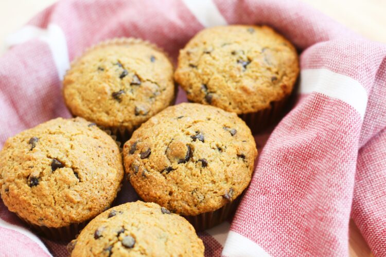 chocolate chip muffins in a red towel